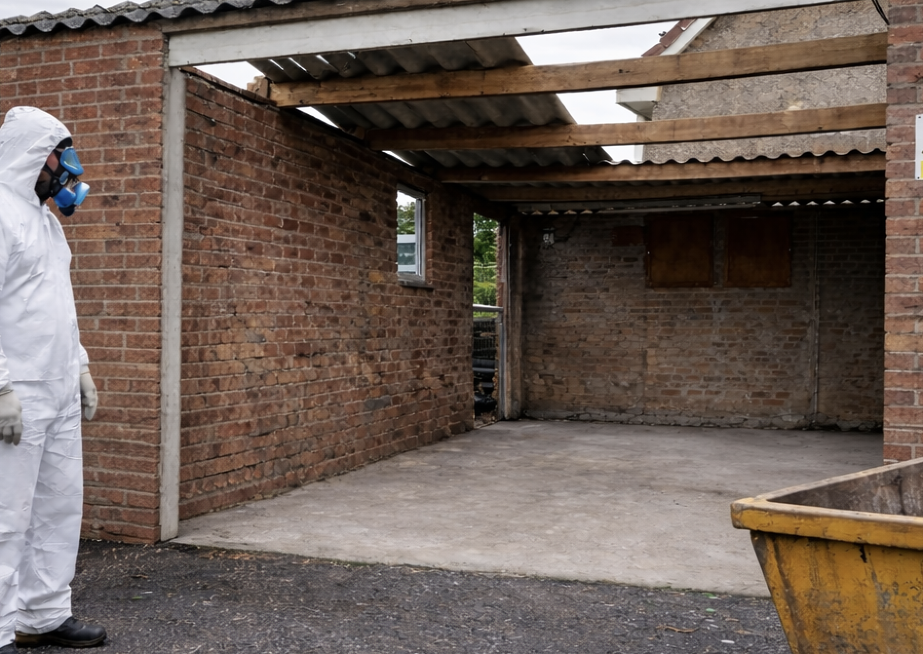 Asbestos garage roof removal in progress by licensed contractor